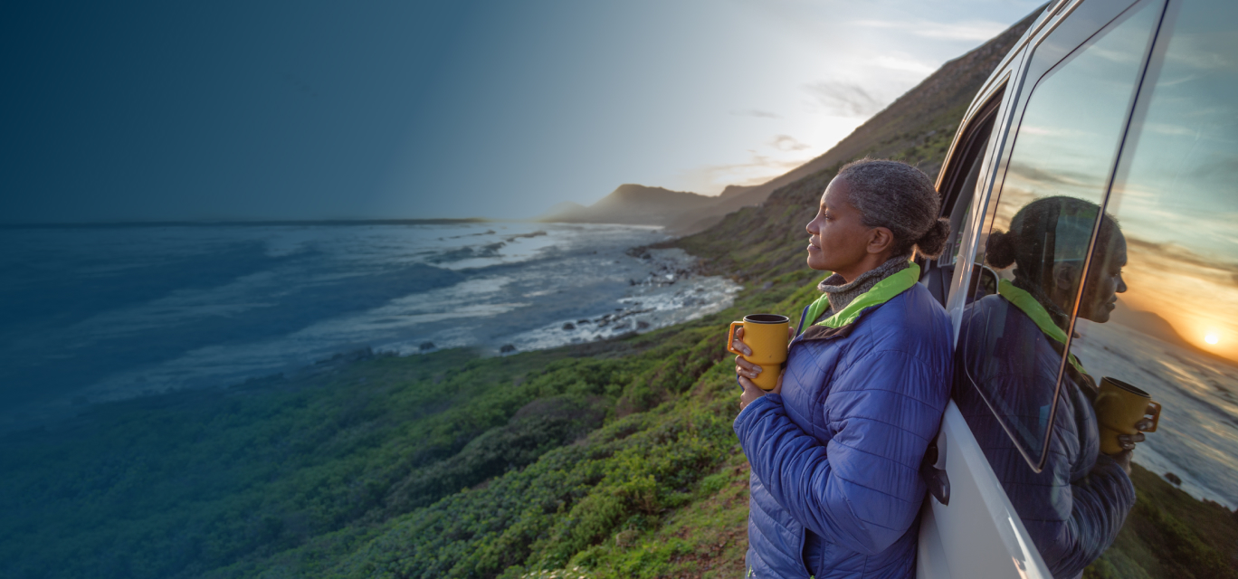 woman looking into distance leaning on van